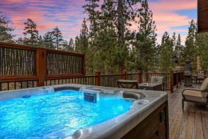 a hot tub on the deck of a house at Bear Creek Lodge with Hot Tub in Big Bear Lake