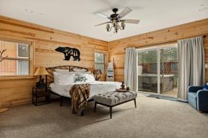 a bedroom with a bed and a ceiling fan at Bear Creek Lodge with Hot Tub in Big Bear Lake +35 photos