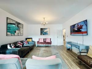 a living room with a couch and a table at Gants Hill House in Redbridge