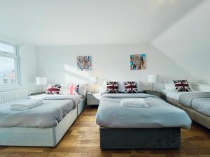 a bedroom with two beds in a room at Gants Hill House in Redbridge