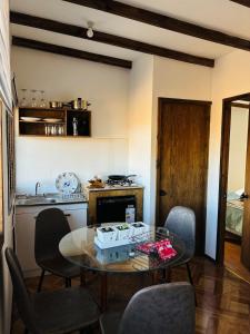 a kitchen with a table and chairs in a room at El Descanso Cabins in Capilla Palacio