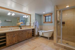 a bathroom with a tub and a sink and a shower at Teton Club in Teton Village +21 photos