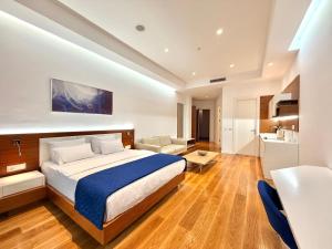 a bedroom with a bed and a living room at Condo Studio Plaza in Budva