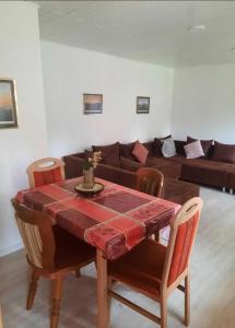 a living room with a table and a couch at Oakwoods in Holste
