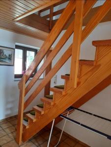a wooden staircase in a house with wooden ceilings at Oakwoods in Holste