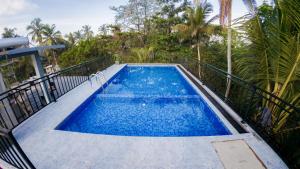 a swimming pool with blue water on a balcony at SouthStone Paradise in Balapitiya