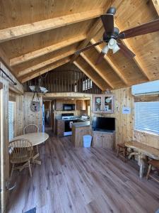 a living room with a ceiling fan and a table at Boulder Creek RV Resort in Lone Pine