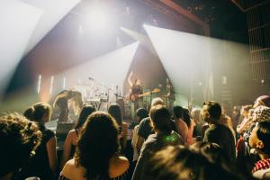 a crowd of people watching a band on a stage at Maison LeBreux - Motel in Petite-Vallée