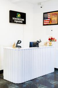a white reception desk in a white room at SouthStone Paradise in Balapitiya +63 photos