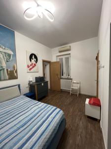 a bedroom with a bed and a dresser in it at Room Saronno + B&B in Saronno