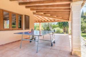 a ping pong table in the middle of a patio at Villa Canescandeu in Port de Pollensa