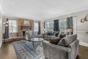 a living room with a couch and a fireplace at Villa Manteago in Bradenton +42 photos