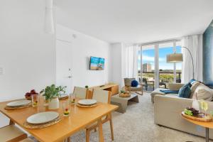 a living room with a table and a couch at Beachwalk Condo in Hallandale Beach