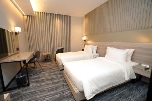 a hotel room with two beds and a desk at Azha Alriyadh in Riyadh +61 photos