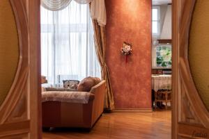 a living room with a couch and a window at City Centre Cozy Guesthouse in Riga
