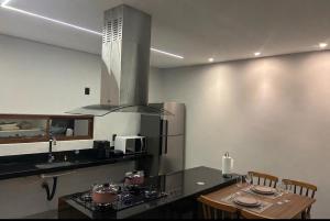 a kitchen with a counter and a stove top oven at Flat Cerejeiras - Condomínio Privado in Bananeiras
