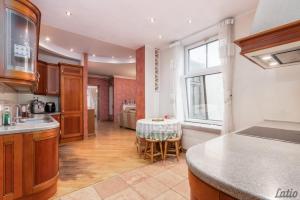 a kitchen with a table in the middle of a room at City Centre Cozy Guesthouse in Riga