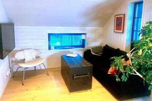 a living room with a black couch and a window at Studio Svartbygget in Åre