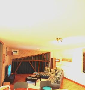 a living room with a couch and a table at CHEZ CELINE en campagne in Mazerny