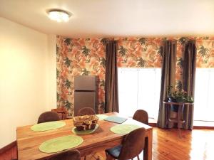 a dining room with a wooden table and chairs at CHEZ CELINE en campagne in Mazerny