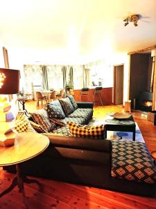 a living room with a couch and a table at CHEZ CELINE en campagne in Mazerny +28 photos