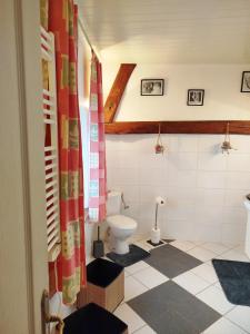 a bathroom with a toilet in a room at CHEZ CELINE en campagne in Mazerny