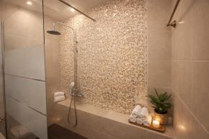 a bathroom with a shower with a glass door at Royal stylish view apartment in Koropi +15 photos