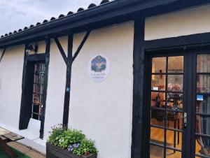 a restaurant with a sign on the side of a building at La Clef d'Or in Magescq