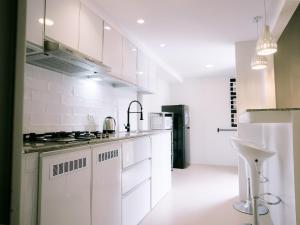 a kitchen with white cabinets and a stove top oven at Joanna Transient Home in Palestina