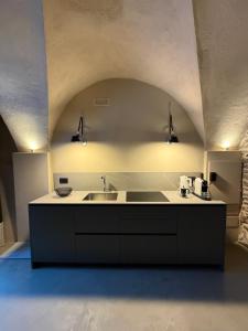 a kitchen with a sink and a counter with lights at Granuit Alpine Home in Sauze di Cesana +27 photos