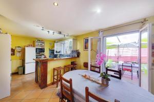 a kitchen and dining room with a table and a refrigerator at Gite la Provençale in Albi