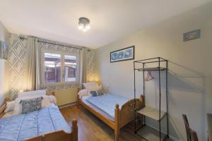 a bedroom with two beds and a shelf in it at Gite la Provençale in Albi +13 photos