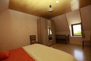 a bedroom with a bed and a window in it at Gite linstant rêvé in Labesserette +7 photos