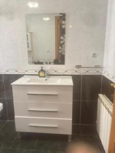 a bathroom with a white sink and a mirror at ElFogaril in Teruel