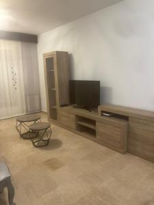 a living room with a flat screen tv on a entertainment center at ElFogaril in Teruel