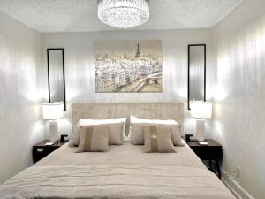 a bedroom with a large bed with two lamps at HPThe Bungalow Spectrum Bojangles Fenced Yard Dog in Charlotte