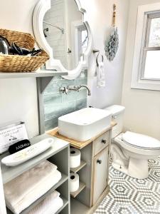 a bathroom with a sink and a mirror at HPThe Bungalow Spectrum Bojangles Fenced Yard Dog in Charlotte +18 photos