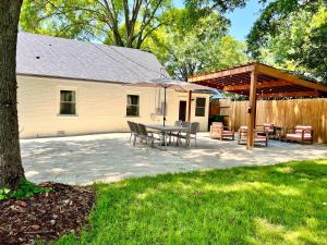 a patio with a table and chairs and an umbrella at HPThe Abode Downtown Bojangles Dogs Welcome Yard in Charlotte