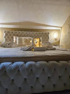 a bedroom with a large bed with a large headboard at Jacuzzy Rooms Andjela in Subotica +82 photos