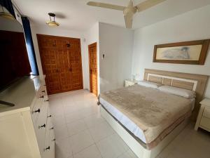 a bedroom with a bed and a television in it at Chalet con piscina y vistas en Urb Marcolina, Alcocéber in Alcossebre +14 photos