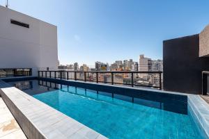 a swimming pool on the roof of a building at Studio with Pool and Gym - DP203 in São Paulo