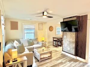 a living room with a couch and a flat screen tv at HPThe Haus BOFA Stadium Spectrum Bojangles Dogs in Charlotte