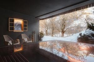 a room with a glass floor and a large window at Les Dolomites Mountain Lodges in San Martino in Badia +57 photos