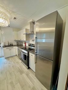 a large kitchen with a stainless steel refrigerator at HPThe Haus BOFA Stadium Spectrum Bojangles Dogs in Charlotte