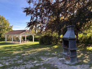 a gazebo and a bird house in a yard at ZEcamping 3 étoiles vue exceptionnelle et soirées animées in Gex