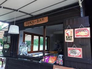 a snack bar with signs on the front of it at ZEcamping 3 étoiles vue exceptionnelle et soirées animées in Gex