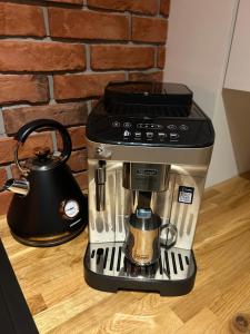 a coffee maker sitting on a counter with a tea kettle at Apartament Bond in Szczawno-Zdrój