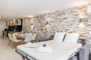 a bedroom with a bed and a brick wall at Cannes Guest House in Cannes