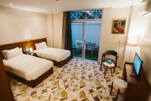 a hotel room with two beds and a balcony at The View Luxor hotel in Luxor +43 photos