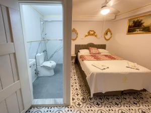 a bedroom with a bed and a shower and a toilet at Lamur Hotel in Alaçatı +116 photos
